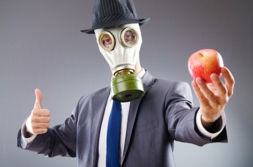 Businessman with gas mask and apple