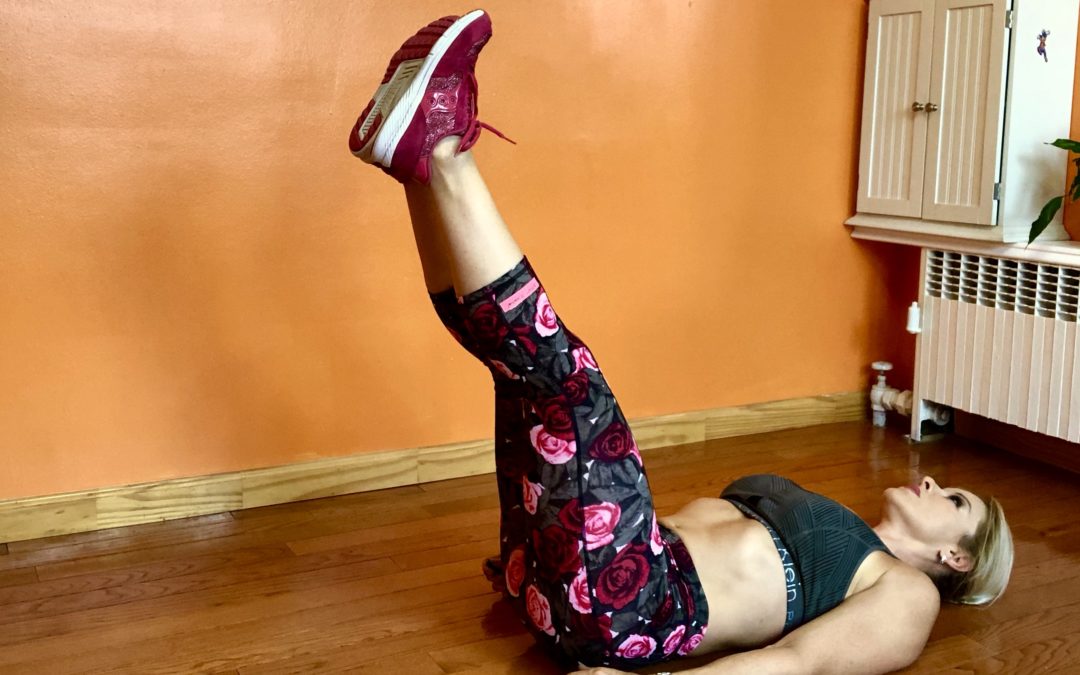 Adriana Albritton doing lying leg raises with hip thrusts